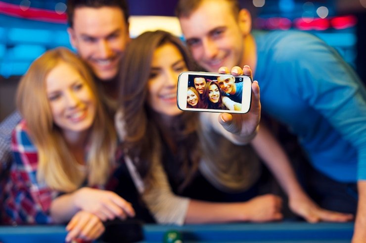 Live dealer seated at Baccarat table with cards and betting layout visible
